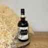 Kraken Black Spiced Rum - na drevenom podklade