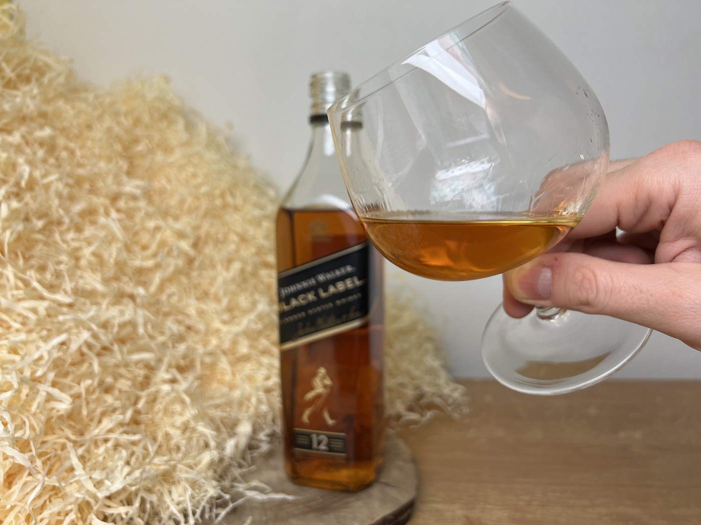 Johnnie Walker Black Label - fľaša a detail na alkohol v pohári